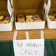 Table of donuts with sign labeled "poll workers only"